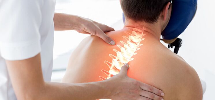A patient with osteochondrosis examined by a doctor.